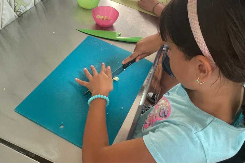 Children rolling dough